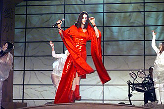 A photo of Madonna in a red kimono performing at the Grammys