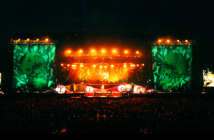 A photo of Metallica performing on an outdoor stadium stage