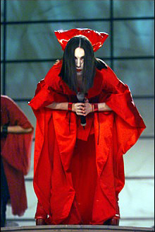 A photo of Madonna in a red kimono performing at the Grammys